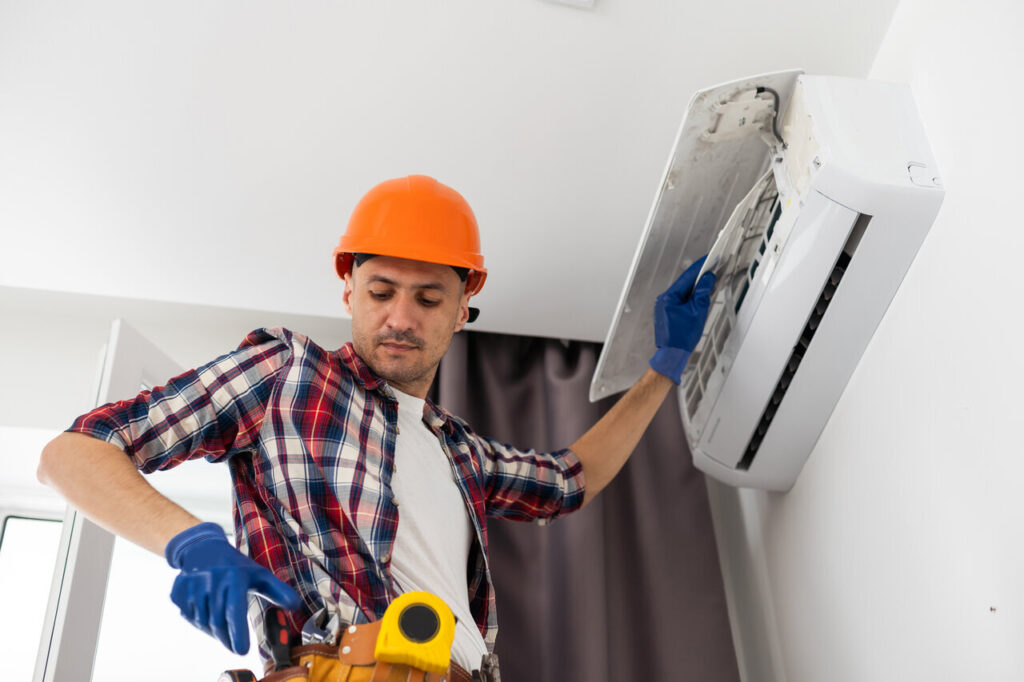 A professional technician repairing an AC system